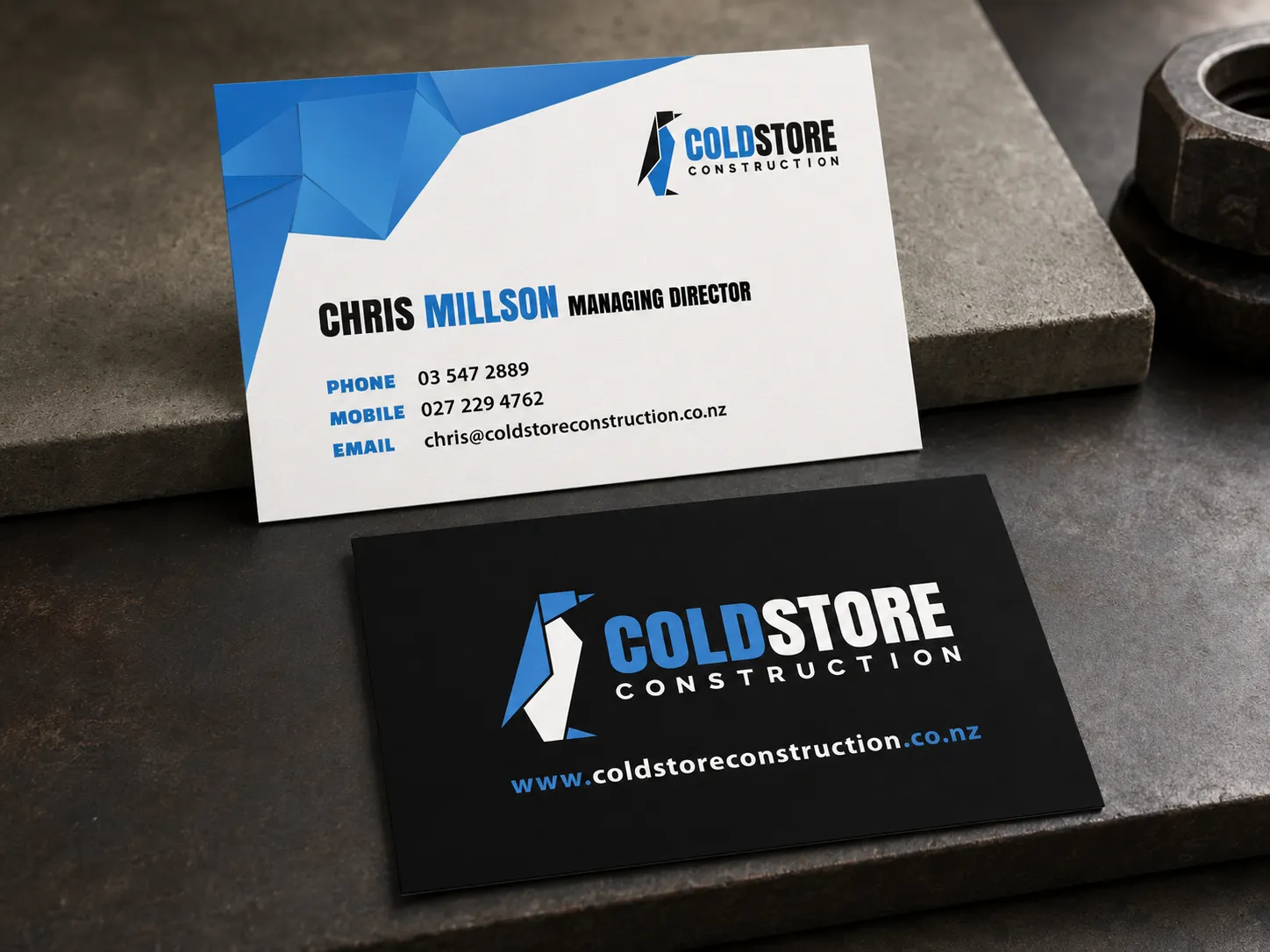 Coldstore Construction business cards in the new identity — a white card for the managing director and a black reverse carrying the logo and website.
